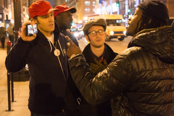 Arguing about dissenting opinions a Trump supporter holds his phone up to show the other man something. (Michael Jordan)