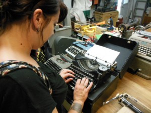 Kat Malone get the feel of an Underwood portable. (Anthony C. Hayes)