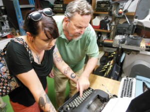 John Moore points out the features of a vintage Remington to writer Kat Malone. (Anthony C. Hayes)