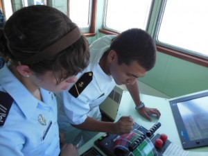 Air Force Cadet Roni Malethorpe get a lesson in throttle control from Midshipman  (Anthony C. Hayes)
