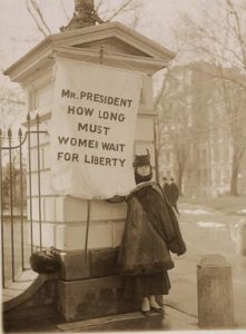 A suffragette protests outside the White House.