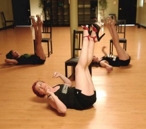 Towson studio members Rachael, Joanna and Chelsea stretch their legs as part of the chair workout. (Stacy Atwell)