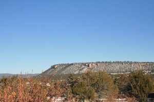 The mesa behind Ancient Way Cafe as seen from El Morro. The cafe is at the foot of the mesa and the sandstone outcropping to the left in the photo.