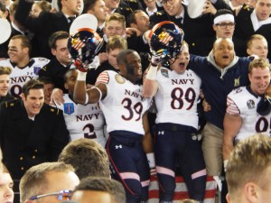 Punter Alex Barta, left, safety Shakir Robinson, middle, and receiver Thomas Wilson were just a few of the players who celebrated with the brigade following Navy's 17-10 win over Army on Saturday. ( Jon Gallo)  